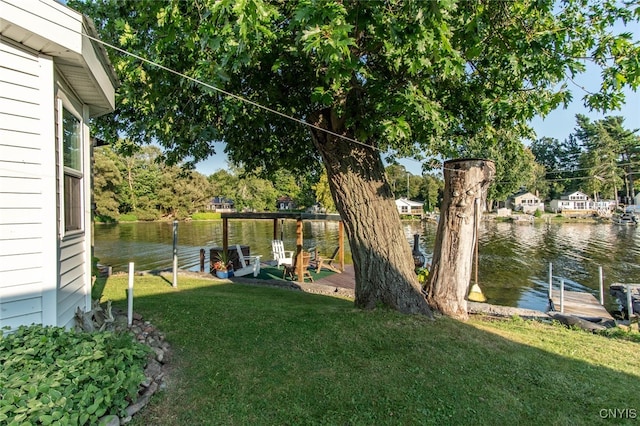 view of yard with a dock and a water view