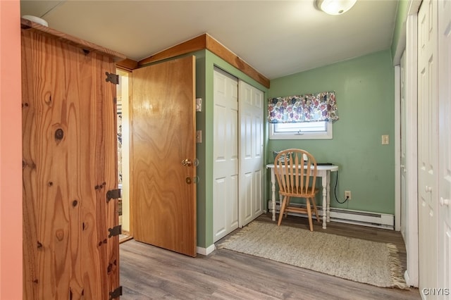 foyer featuring light hardwood / wood-style flooring and baseboard heating