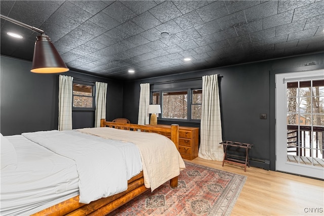 bedroom featuring light hardwood / wood-style flooring and access to exterior