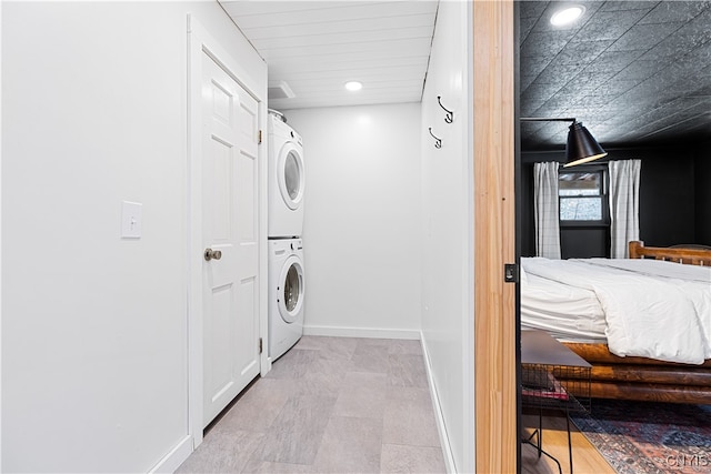 laundry area featuring stacked washer / dryer