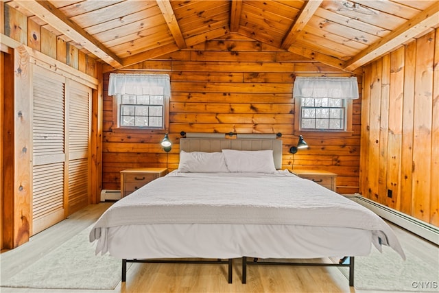 bedroom with light wood-type flooring, wood ceiling, and a baseboard radiator