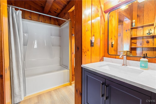 bathroom with beamed ceiling, vanity, shower / bath combo, wood ceiling, and hardwood / wood-style flooring