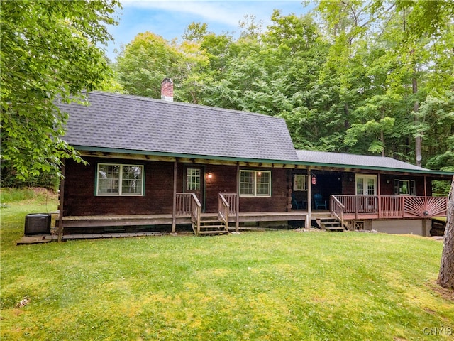 view of front of house with a front yard and central AC unit