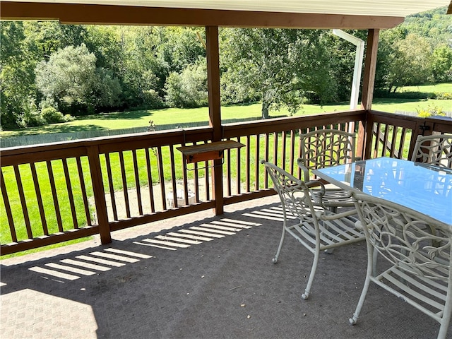 wooden terrace with a yard