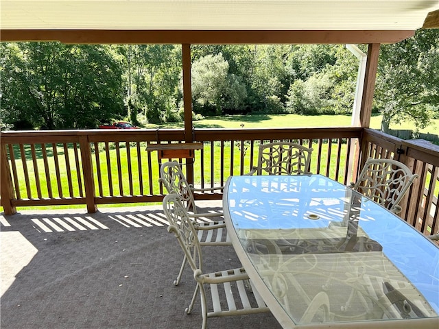 wooden deck featuring a lawn