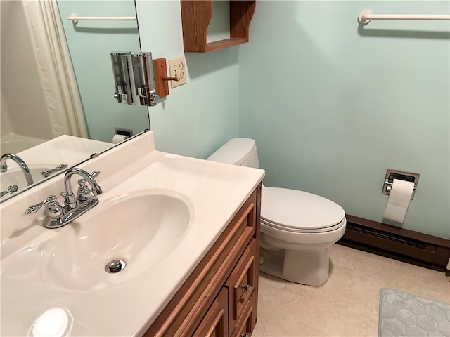 bathroom with a baseboard heating unit, vanity, toilet, and tile patterned floors