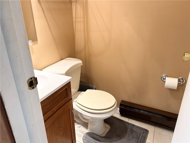 bathroom featuring a baseboard heating unit, vanity, toilet, and tile patterned flooring