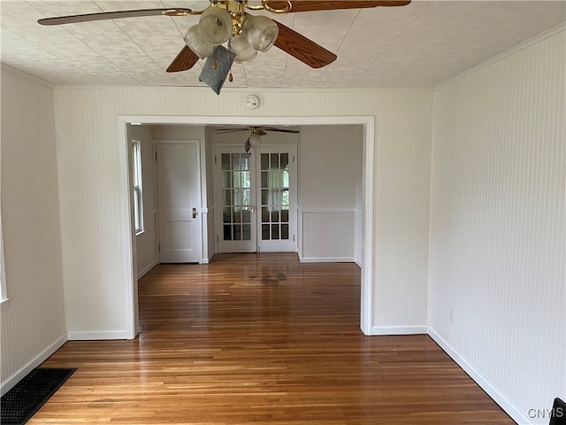 empty room featuring hardwood / wood-style floors, ceiling fan, and french doors