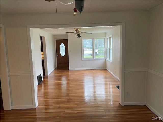 entrance foyer featuring ceiling fan and wood-type flooring