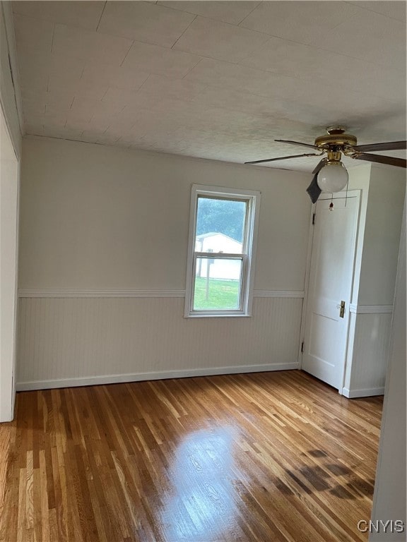 unfurnished room featuring hardwood / wood-style floors and ceiling fan