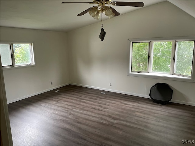 spare room featuring dark wood-type flooring, lofted ceiling, and ceiling fan