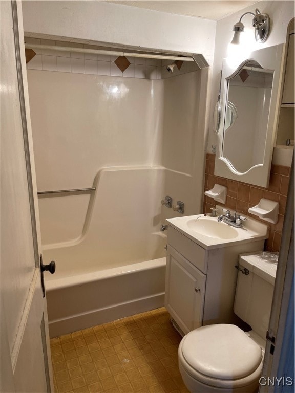 full bathroom with vanity, toilet, decorative backsplash, and  shower combination