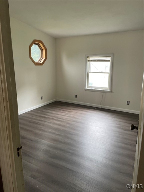 empty room featuring dark wood-type flooring