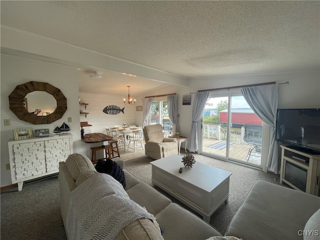 living room with a textured ceiling, carpet flooring, and a chandelier