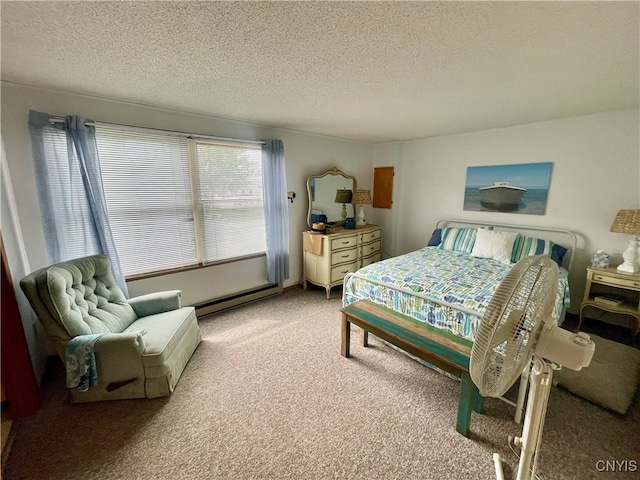 bedroom featuring carpet floors, a textured ceiling, and a baseboard heating unit