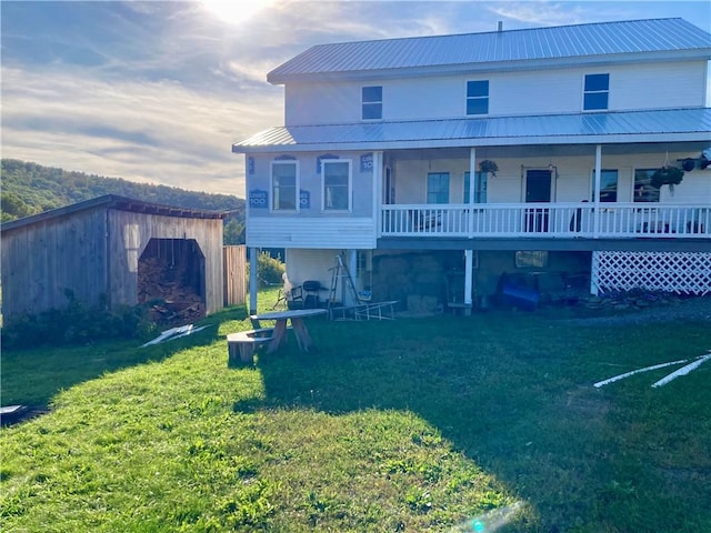 view of front of home with a front yard and covered porch