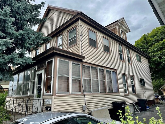 view of home's exterior with a sunroom