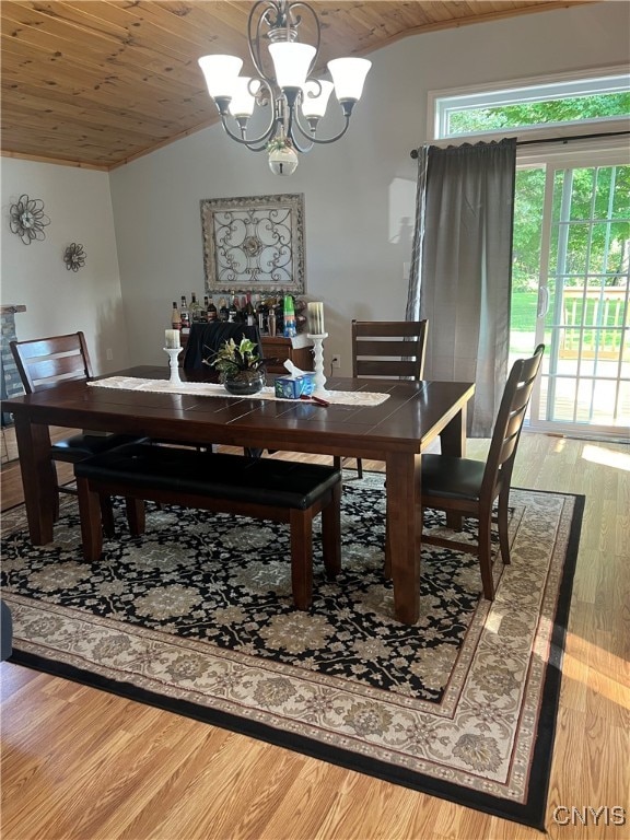 dining space featuring wooden ceiling, vaulted ceiling, hardwood / wood-style flooring, and an inviting chandelier