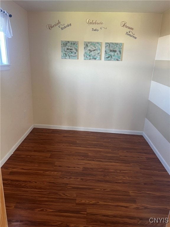 unfurnished room featuring dark wood-type flooring