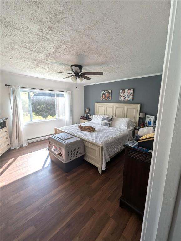 bedroom featuring a textured ceiling, a baseboard radiator, ceiling fan, and dark hardwood / wood-style floors