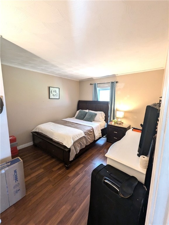 bedroom featuring dark wood-type flooring and ornamental molding