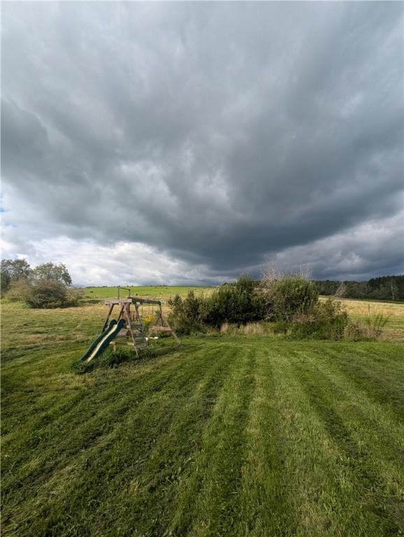 view of yard with a rural view and a playground