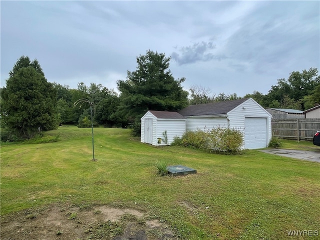 view of yard with a storage shed and a garage