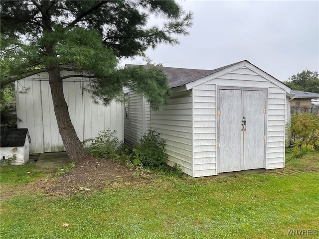 view of outbuilding featuring a lawn