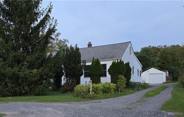 view of side of property with an outdoor structure and a garage