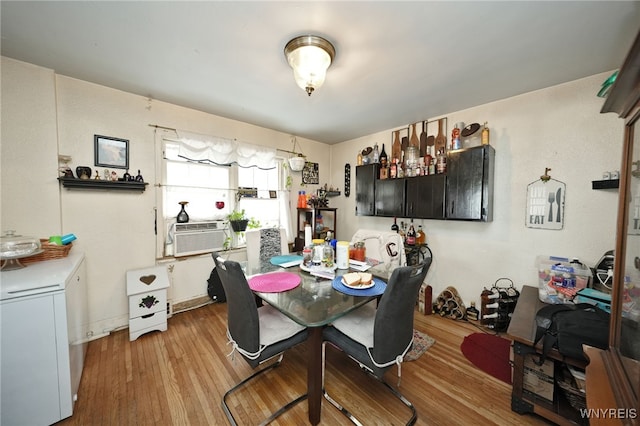 dining room with cooling unit and hardwood / wood-style floors