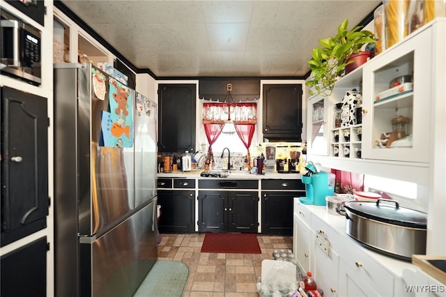 kitchen with sink, appliances with stainless steel finishes, and white cabinets