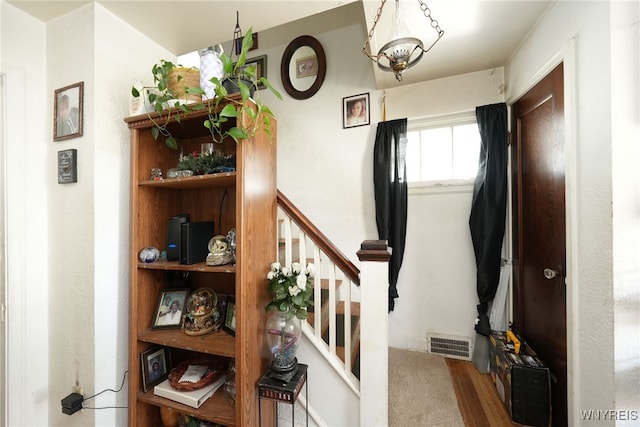 stairs with wood-type flooring