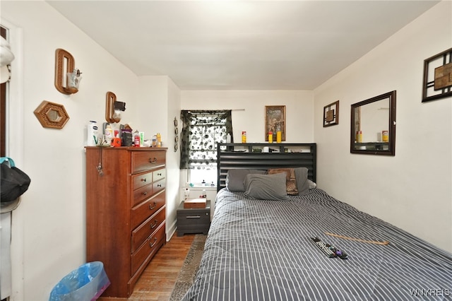 bedroom with hardwood / wood-style floors