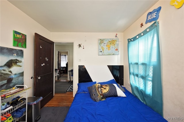 bedroom with dark wood-type flooring