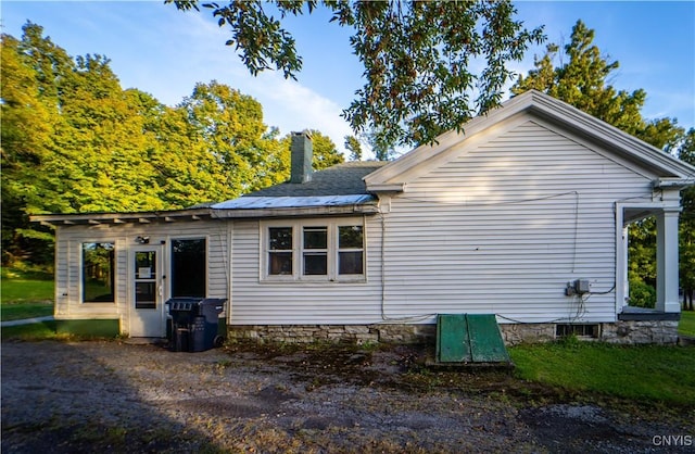 view of side of property featuring a chimney