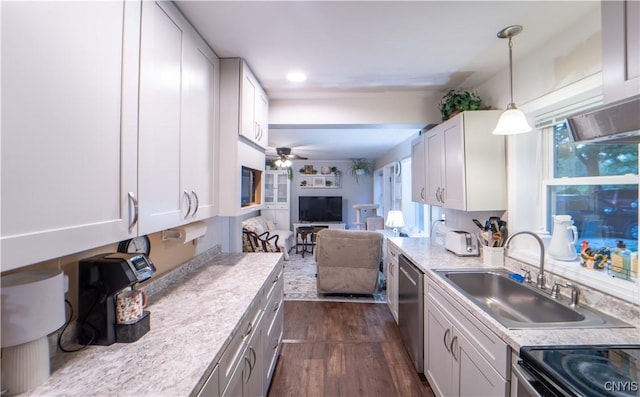 kitchen with a ceiling fan, a sink, light countertops, stainless steel dishwasher, and open floor plan