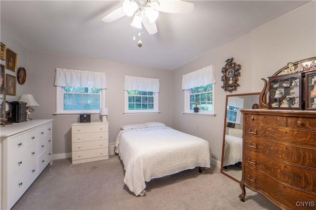 bedroom with baseboards, light carpet, and ceiling fan