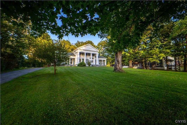 neoclassical / greek revival house with a front lawn