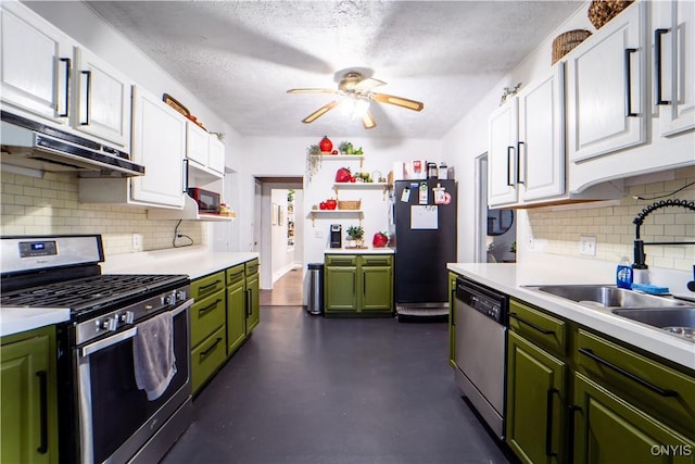 kitchen featuring green cabinetry, a sink, stainless steel appliances, light countertops, and white cabinets