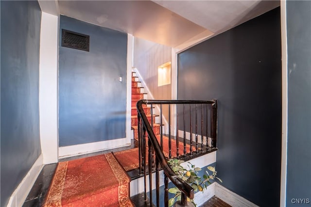 stairs featuring visible vents and baseboards