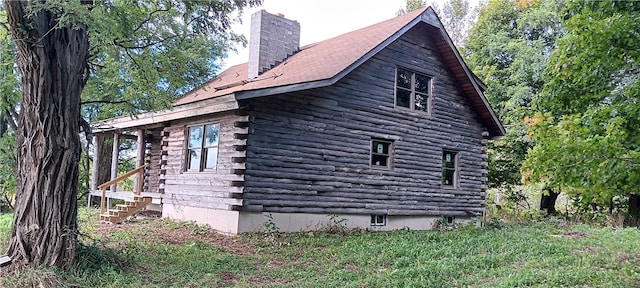 view of side of home with a yard