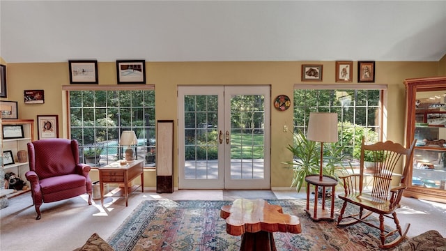 interior space featuring french doors and light carpet