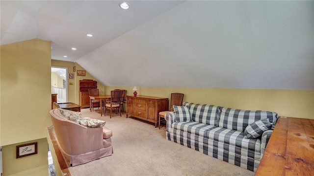 interior space with light carpet and vaulted ceiling