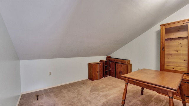 office area with lofted ceiling and light colored carpet