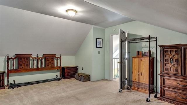 carpeted bedroom featuring lofted ceiling