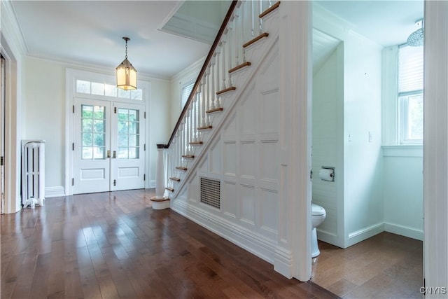 foyer featuring stairs, french doors, dark wood-style flooring, and ornamental molding