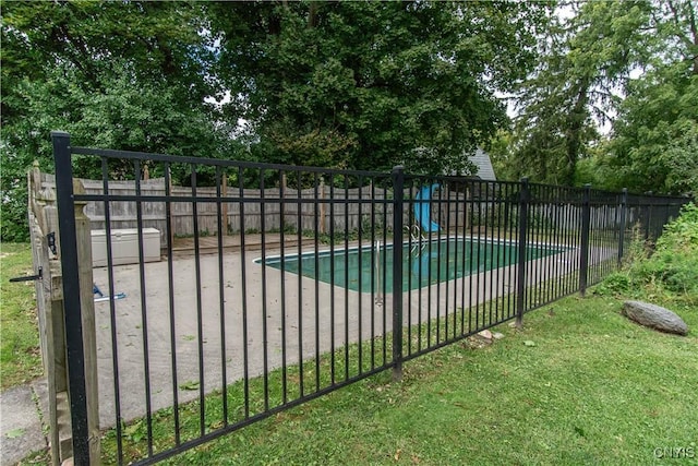 view of swimming pool with a fenced in pool and fence