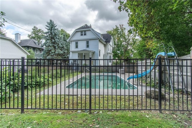 view of gate featuring fence and a fenced in pool