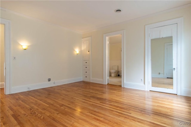 interior space featuring light wood-type flooring, visible vents, and baseboards