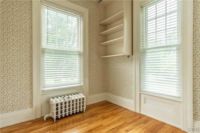 interior space featuring wallpapered walls and light wood-type flooring